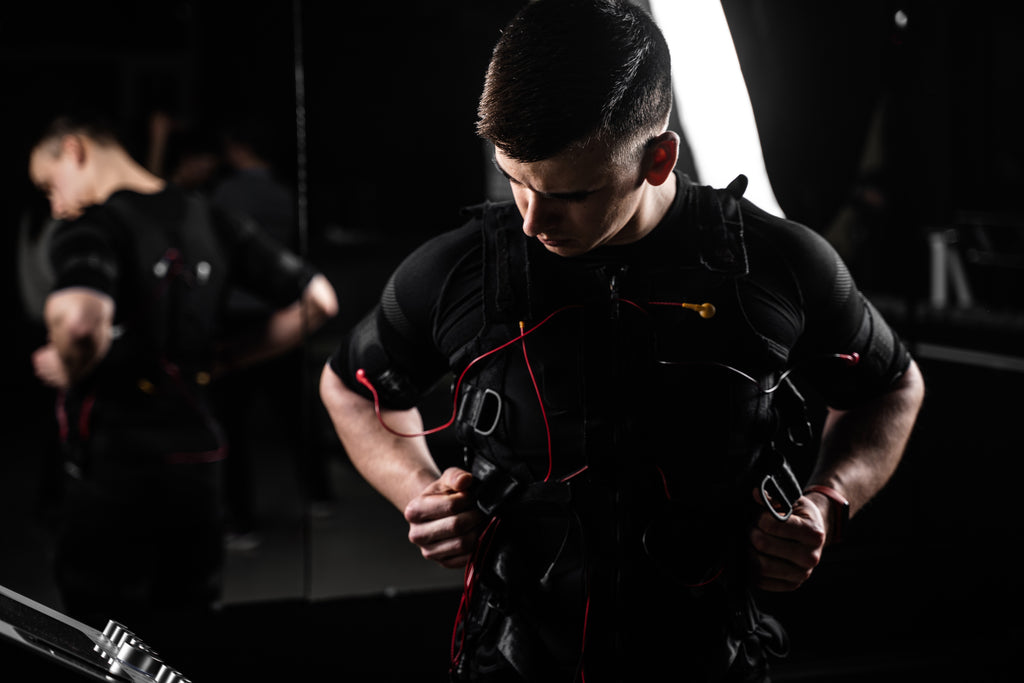 EMS electric muscle stimulator suit worn by man during gym training