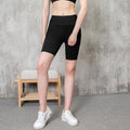 MotionMade black high-waisted compression athletic shorts with moisture-wicking fabric and side pockets on a model.
