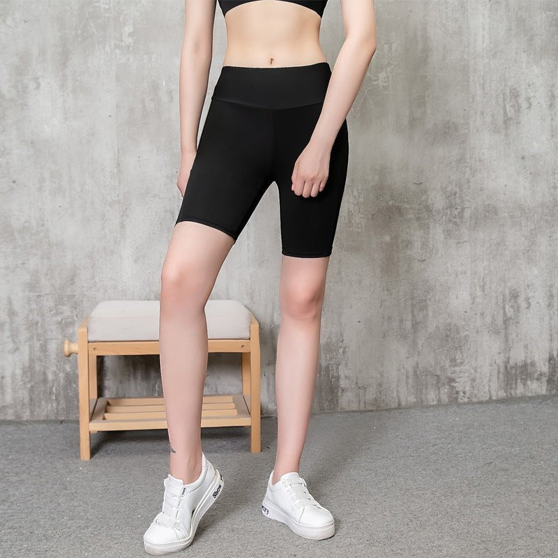 MotionMade black high-waisted compression athletic shorts with moisture-wicking fabric and side pockets on a model.