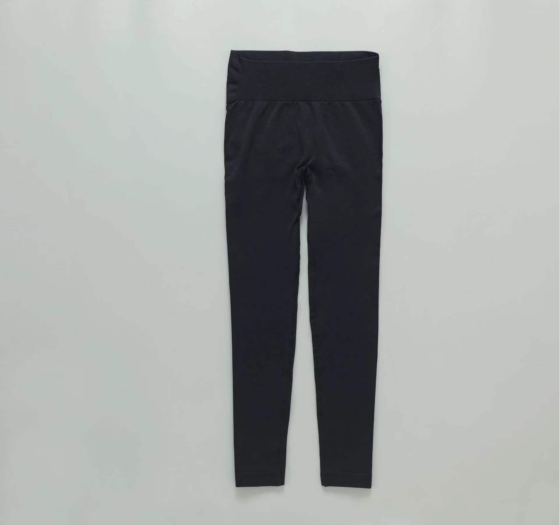 MotionMade high-waisted black yoga leggings with moisture-wicking four-way stretch fabric for gym and workout training.