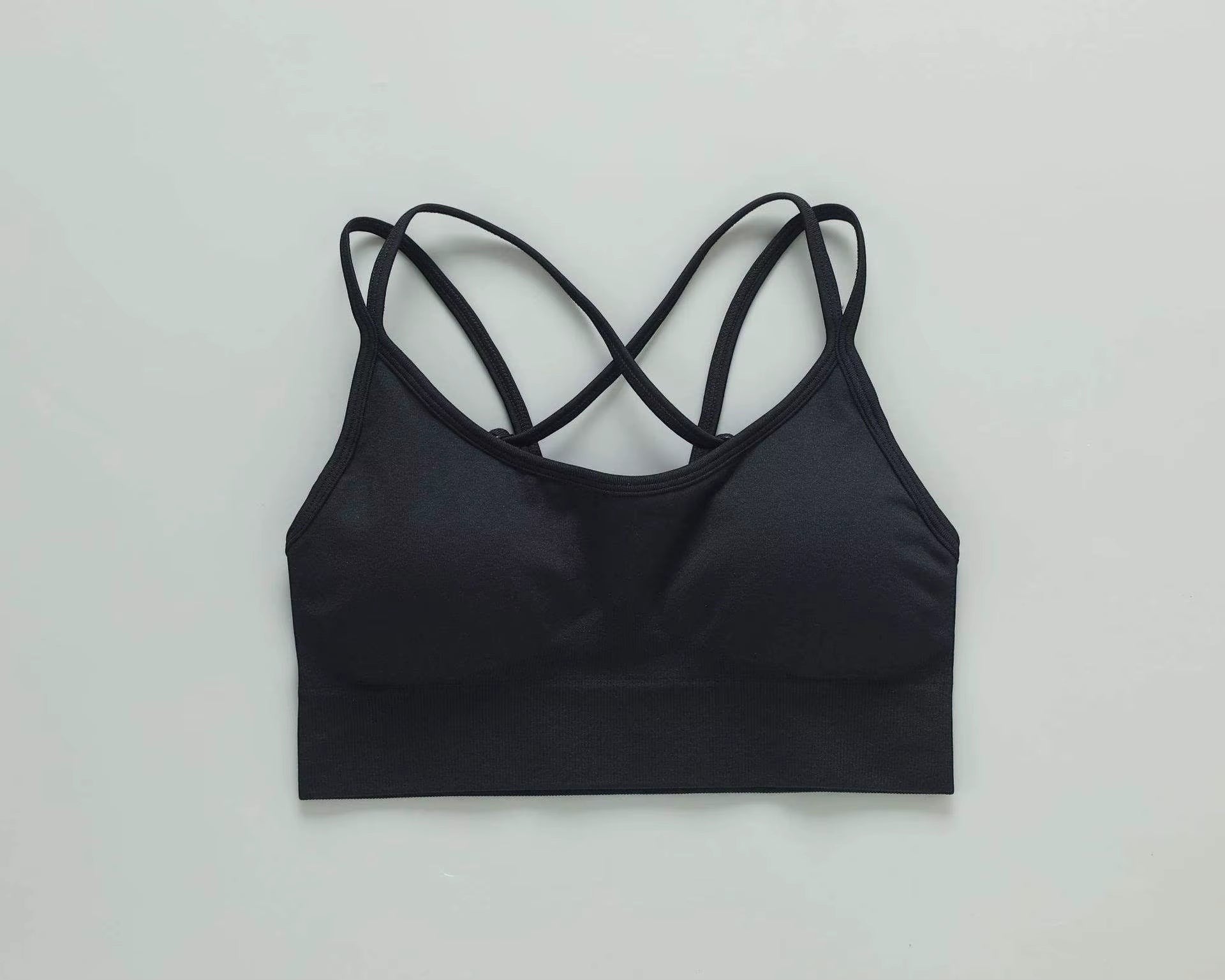 MotionMade black push-up sports bra with crisscross back straps, ideal for yoga and gym workouts.