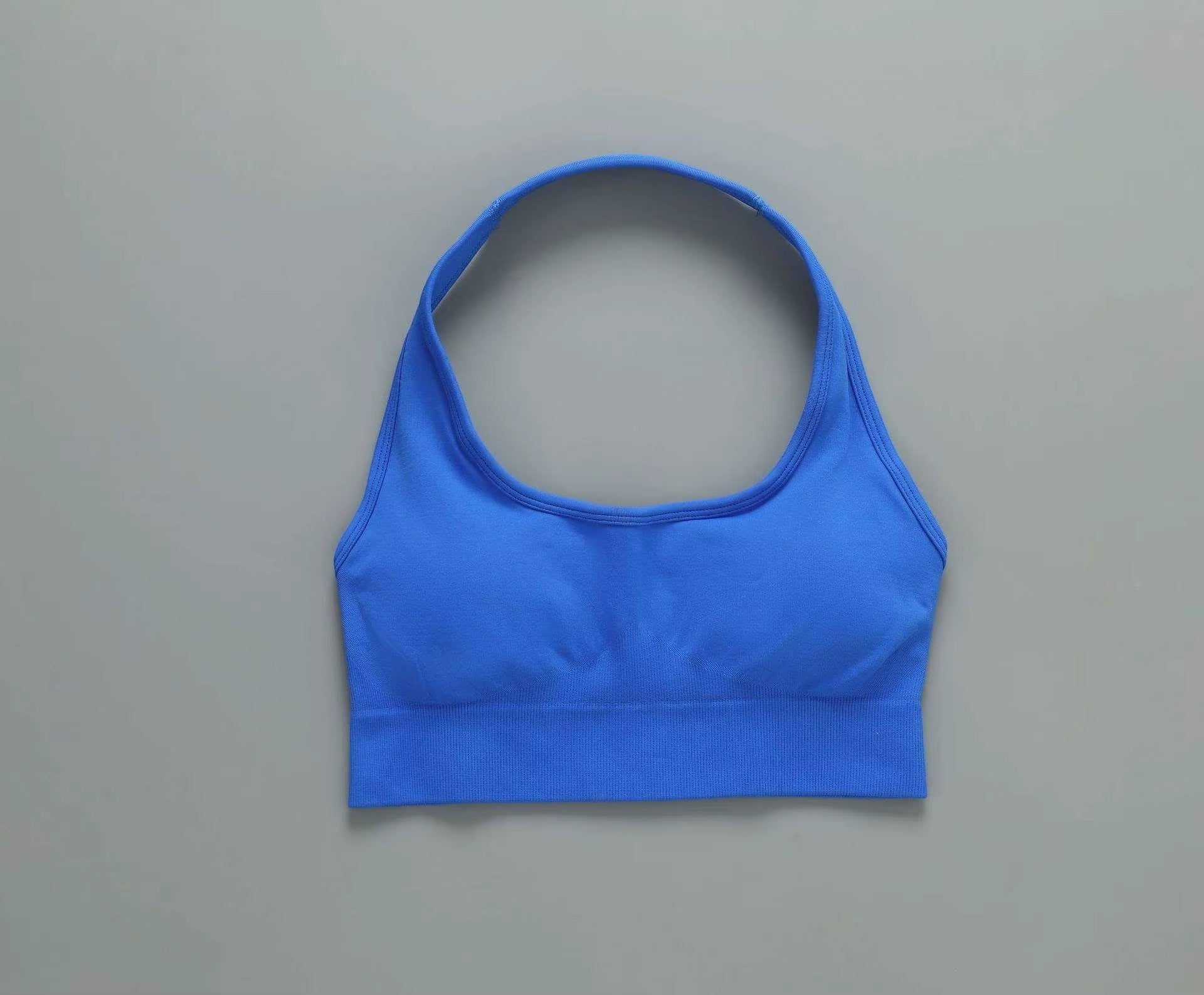 MotionMade blue push-up sports bra with moisture-wicking fabric for yoga and gym workouts.