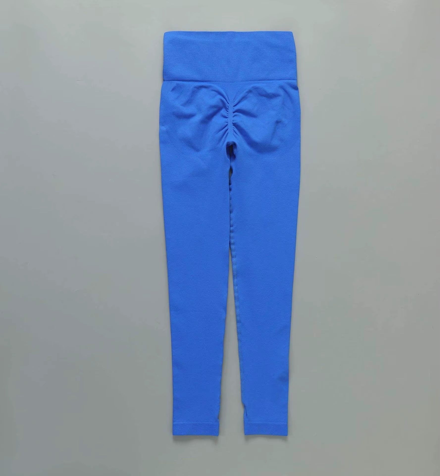MotionMade blue high-waisted seamless leggings with push-up scrunch detail for yoga and gym workouts.