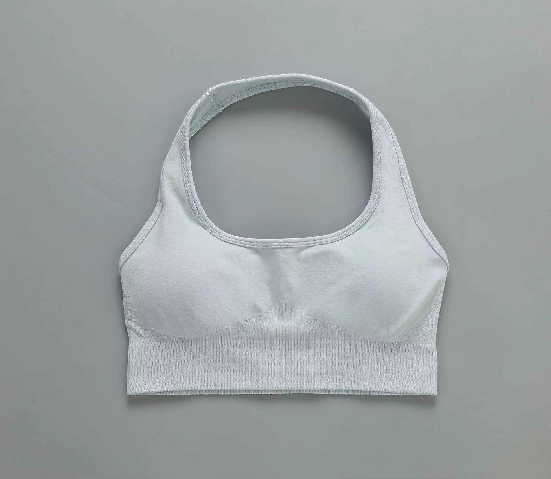 MotionMade light blue push-up sports bra with moisture-wicking four-way stretch fabric for yoga and gym workouts.