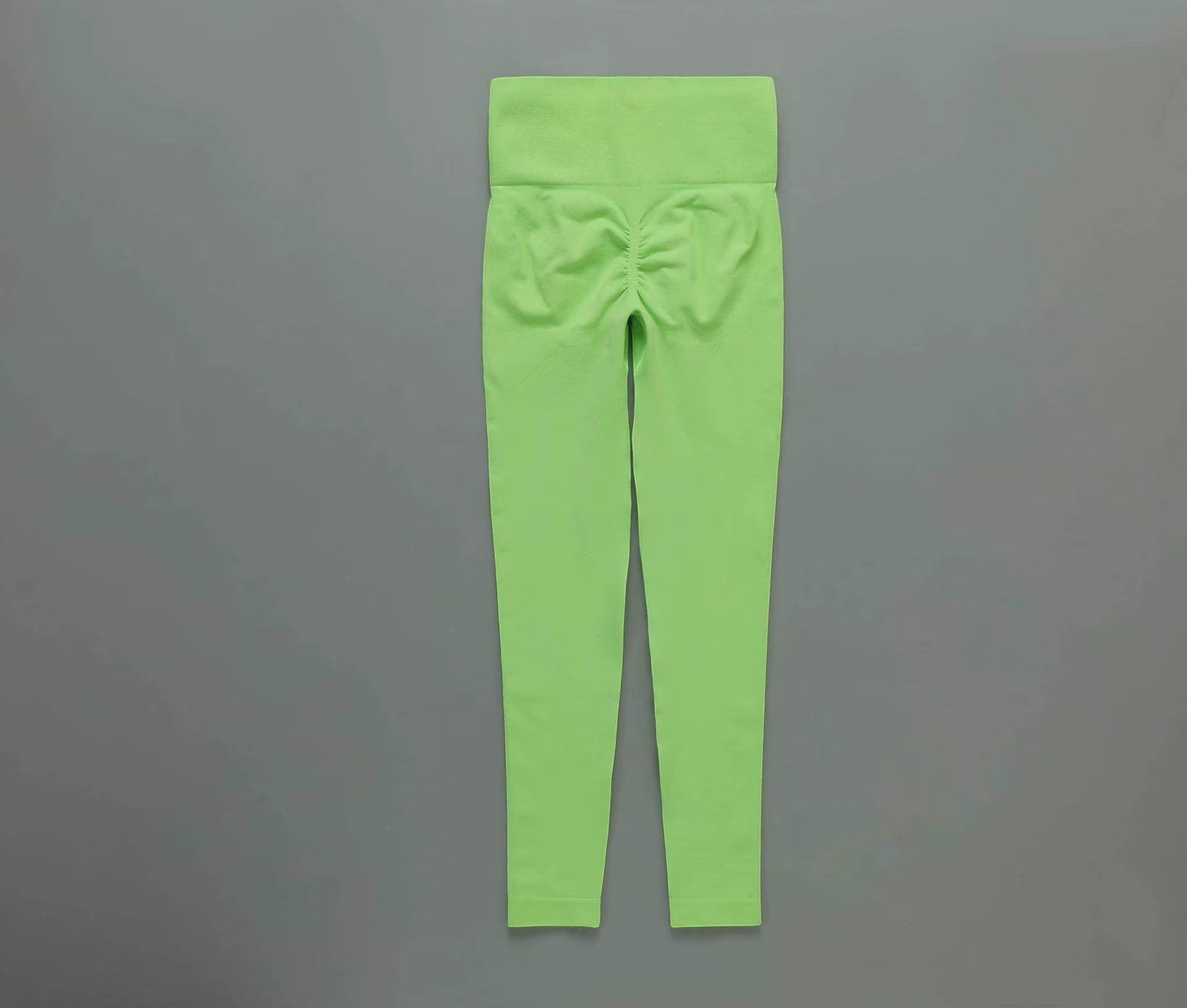 MotionMade high-waisted lime green seamless leggings with push-up scrunch detail for yoga and gym workouts.