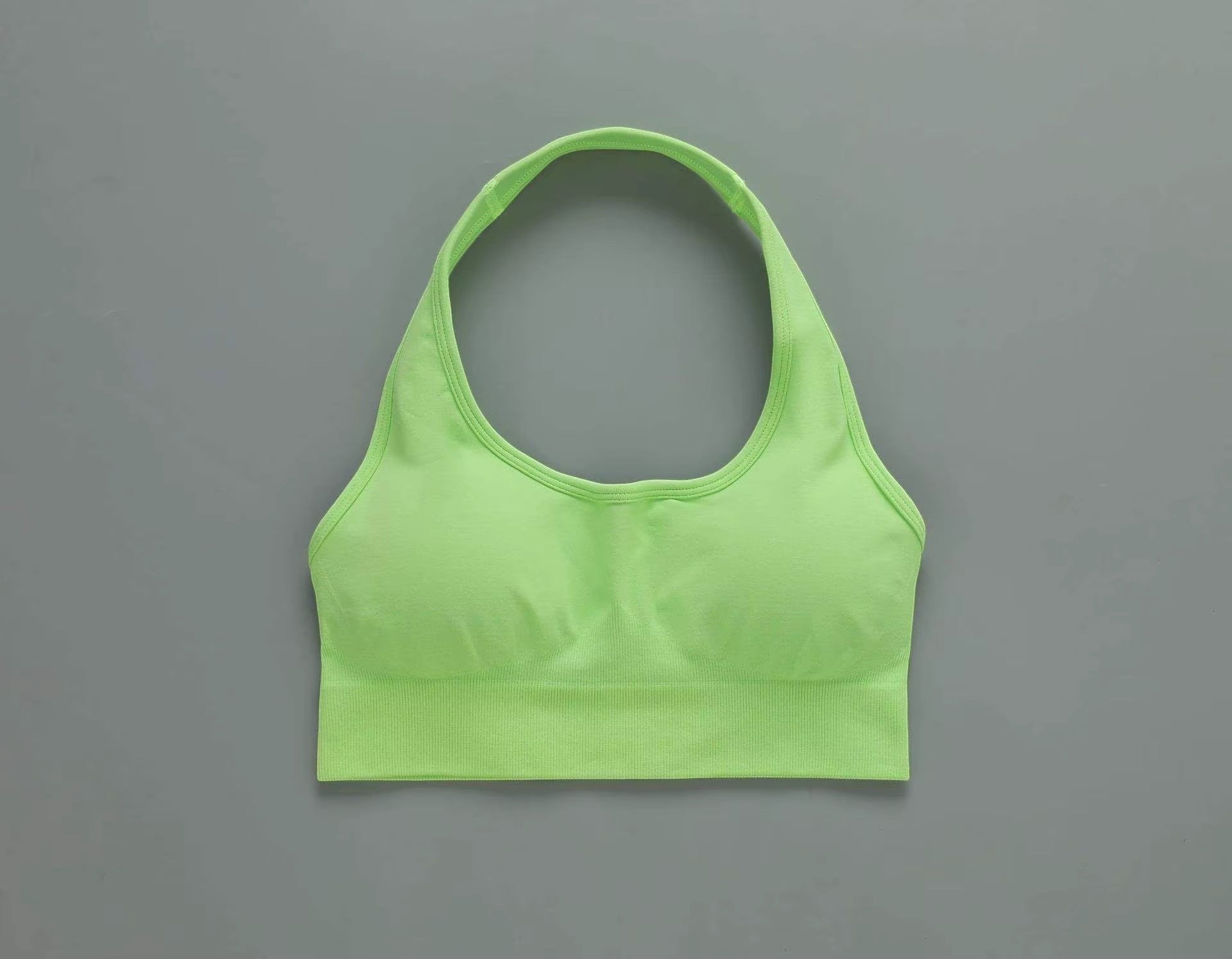 MotionMade lime green seamless push-up sports bra with a racerback design for yoga and gym workouts.