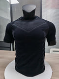 MotionMade black seamless compression shirt with body-mapping knit patterns for athletic performance and support.