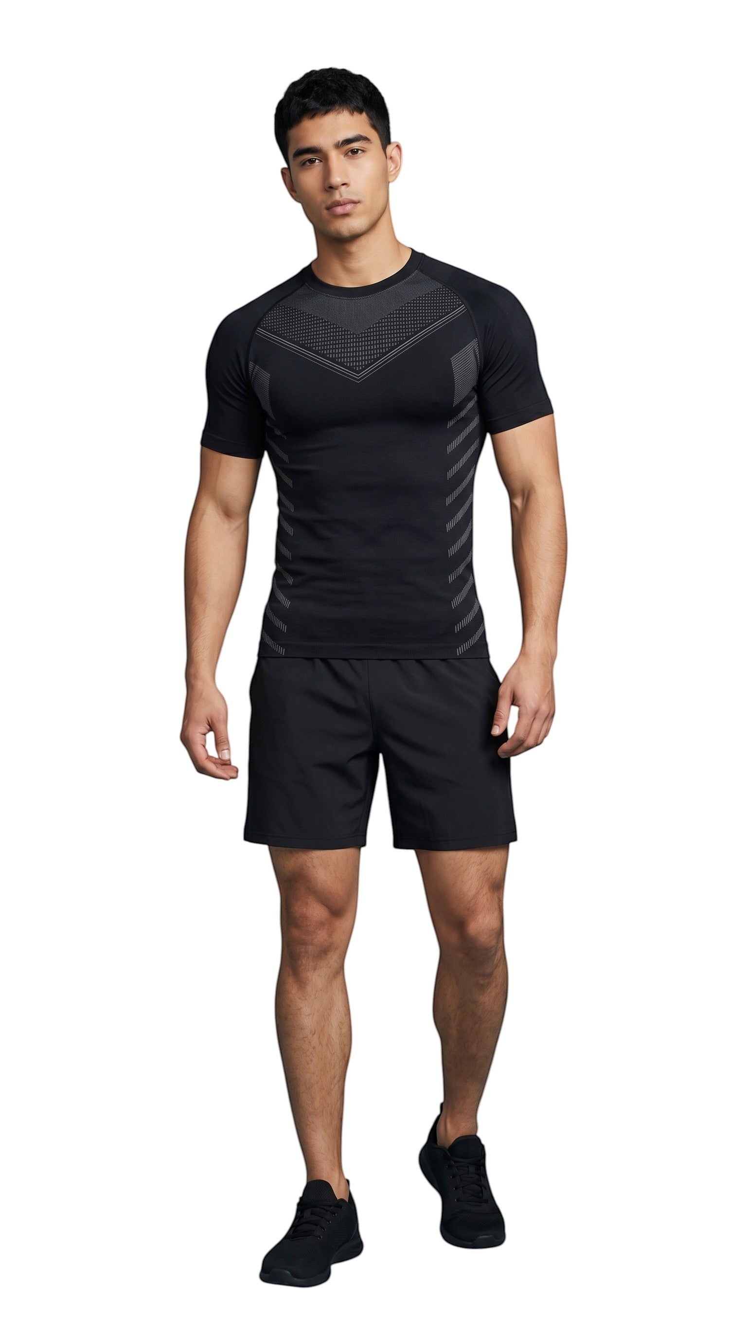 Model wearing a black MotionMade knitted compression shirt with seamless body-mapping design and athletic shorts.