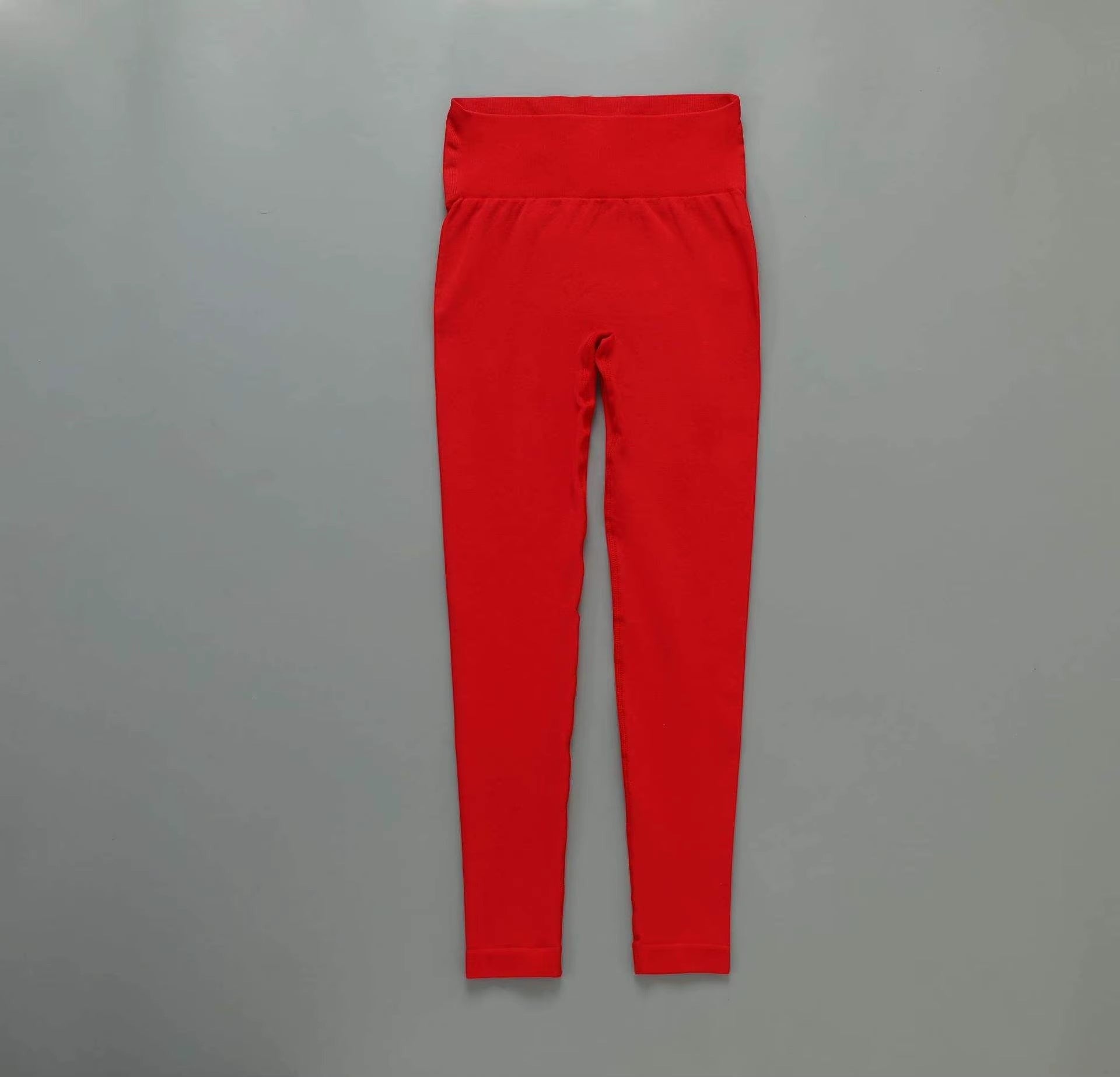 MotionMade red high-waisted seamless yoga leggings with compressive fit for gym workouts and athletic training.
