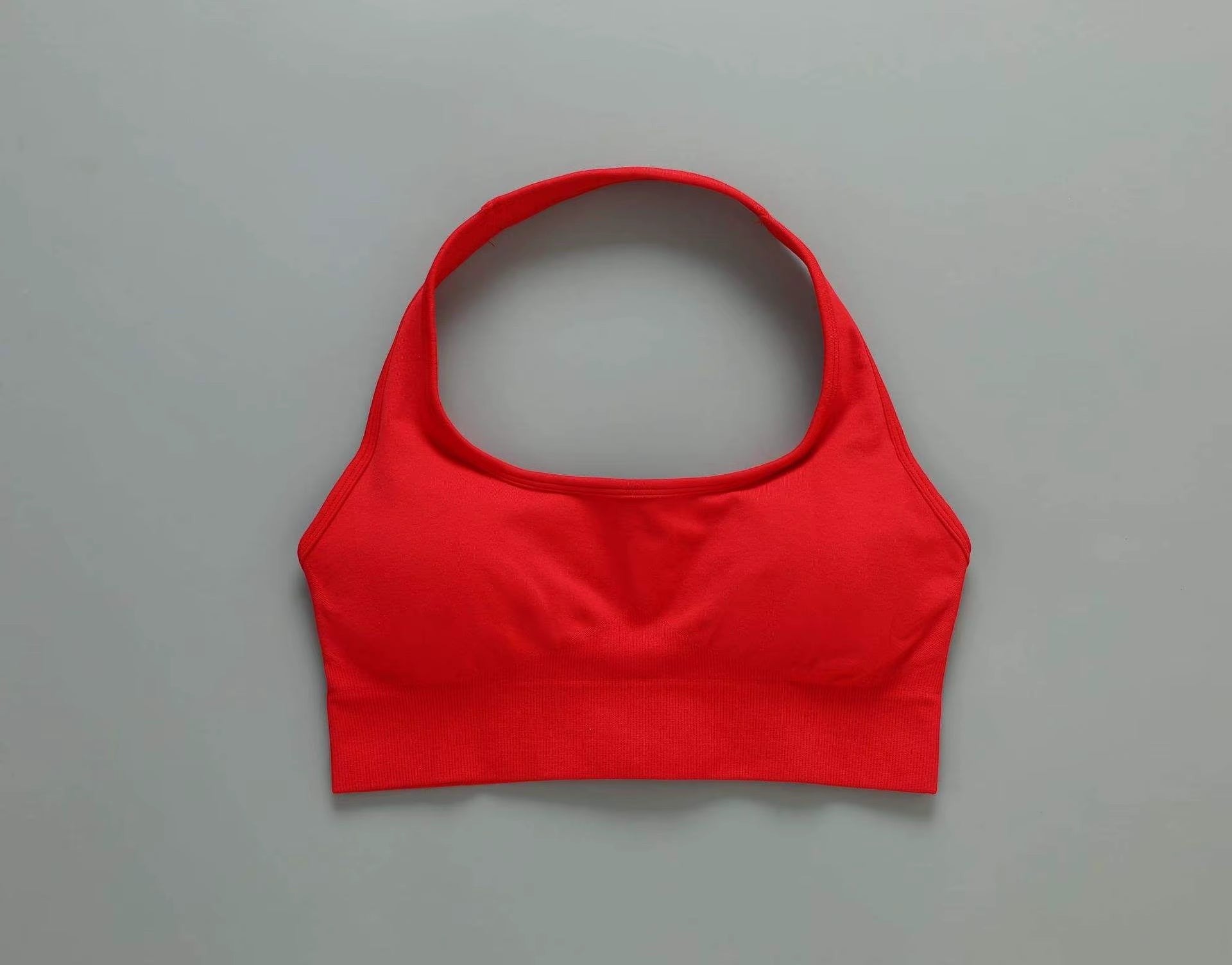 MotionMade red push-up sports bra with a wide supportive band and moisture-wicking fabric for gym and yoga.