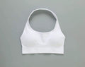 MotionMade white push-up sports bra with a halter neckline, made from moisture-wicking four-way stretch fabric.